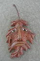 June 2004 - This is a Maple Leaf with a face in it. 7 inches long and 5 1/2 inches wide, carved out of basswood and finished with acrylic paint followed by paste wax.