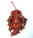 August 2004 - This is a Maple Leaf with a face in it. 7 inches long and 5 1/2 inches wide, carved out of basswood and finished with acrylic paint followed by paste wax.