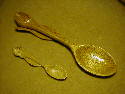 The large spoon is 9 inches long and the small one is 4.25 inches. Bothe are carved from butternut wood. The big one is finished with varathane and the small one with floor wax. June 2002.