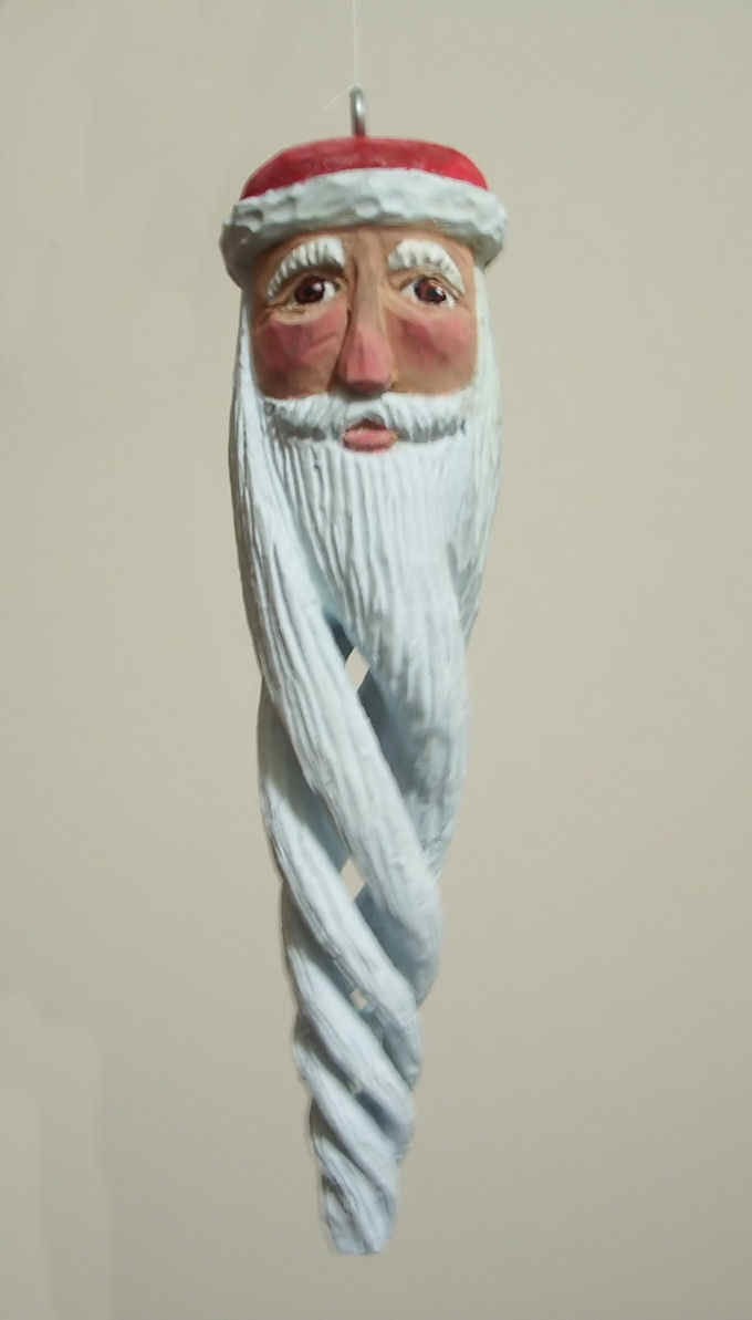 December, 2005 - This Santa is about 6 inches tall, carved from Basswood and finished with acrylics and boiled linseed oil. This was my first attempt at making a hollowed spiral carving.