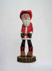 Feb - 2006 The cowboy Santa is about 7 inches tall, carved from basswood, painted in acrylic and finished off with double boiled linseed oil. He stands on a chunk of Elm.