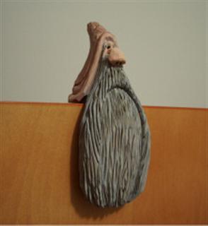 Mar. 2006 - This little guy was also inspired by a picture I saw in a carving magazine. He is cut from a block of basswood that measures 2" x 2" x 6" and painted with acrylics.