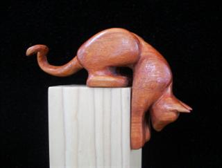 May 2006 - This stylized stretching cat is carved from willow, sanded and finished with 3 coats of laquer and one coat of paste wax. He measures about 5 inches long and 3 inches high.