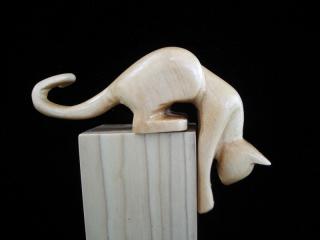 May 2006 - This stylized stretching cat is carved from basswood, sanded and finished with 3 coats of laquer and one coat of paste wax. He measures about 5 inches long and 3 inches high.
