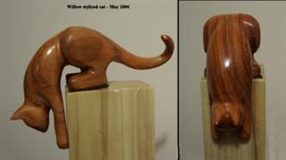 May 2006 - This stylized stretching cat is carved from willow, sanded and finished with 3 coats of varathane. He measures about 5 inches long and 3 inches high.