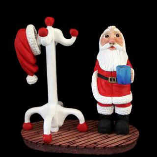 Jan 2008 - This is the third one of these carvings I have done. Like the first one (#140) and the second one (#171) this little guy is about 7.5" tall, all carved from basswood and painted with acrylics. The difference is that I used one piece of maple laminate for the floor and this time the coat rack is white with red.