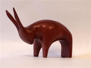 March 2010- This is a small stylized goat made from a piece of African Rosewood. He measures about 3 inches long and 2 inches tall and is part of a series of small stylized animals I've carved.