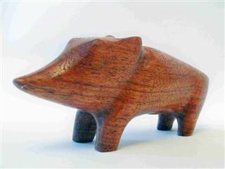 April 2010- This is a small stylized pecary that I carved out of a small piece of exotic hardwood I had kicking around. He measures about 3 inches long and 2 inches tall and is part of a series of small stylized animals I've carved.
