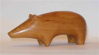 April 2010- This is a small stylized pig that I carved out of a small piece of oak hardwood I had kicking around. He measures about 3 inches long and 2 inches tall and is part of a series of small stylized animals I've carved.